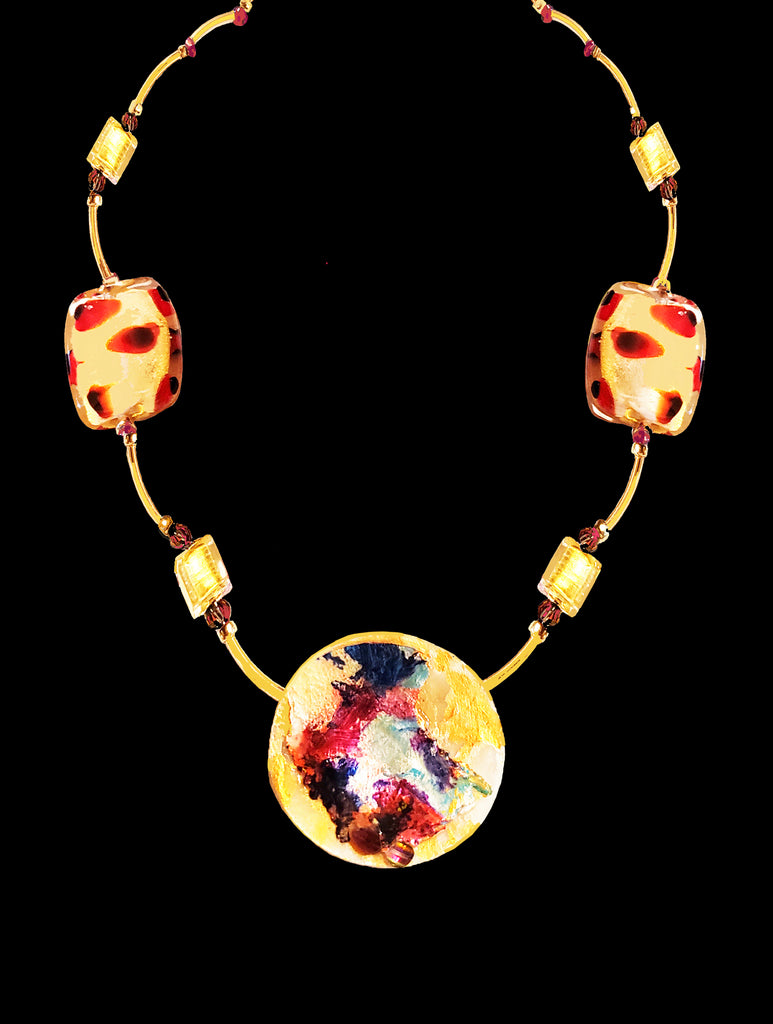 14 carat yelllow gold elbow necklace, lobster clasp and findings. in between links are 4 gold modern Venetian squares, and two larger Venetian glass rectangles. These are gold background with deep red leopard spots. Focal pendant is palette scrapings and graffiti on raw mother of pearl in gold, white, deep red, navy and hints of aqua, with a very rarintage Swarovski pagoda bead (color is called volcano-primarily deep red).