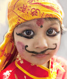 Nepalese child in bright yellow and red costume